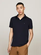Chomba Tommy Hilfiger color azul marino de piqué de algodón elástico, con cuello clásico, tapeta de dos botones y logo bordado en el pecho.