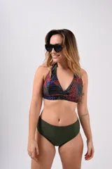 Conjunto de bikini con corpiño triangular con estampado abstracto en tonos violeta, rosa y negro, y bombacha tiro alto negra.