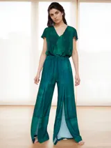 Mono de vestir verde esmeralda con estampado abstracto, escote en V, mangas cortas y pantalón palazzo con aberturas laterales.