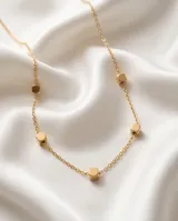 Collar de cadena fina con dije de cubo pequeño en color dorado.