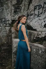 Top azul petróleo sin mangas, tejido en hilado brillante, con escote drapeado y choker integrado.