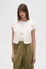 Chaleco corto de algodón con diseño capitoneado, cuello redondo y volados en los hombros.