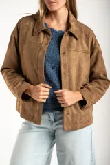 Sobrecamisa de gamuza sintética color camel, con corte oversize, cuello clásico con detalle de costura, cierre frontal con botones metálicos y mangas largas.
