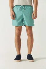 Short de baño liso para hombre, con cintura elástica y cordón ajustable. Cuenta con dos bolsillos laterales, un bolsillo trasero y logo bordado en el ruedo.