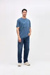 Remera de algodón con efecto lavado, manga corta y cuello redondo. Presenta un estampado central con diseño de estrella y detalles desgastados.