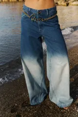 Jean de tiro medio, corte oversize y pierna ancha, con efecto degradado de azul oscuro a celeste claro. Confeccionado en denim 100% algodón, presenta badana de PU y avíos metálicos.
