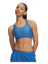 Top deportivo Under Armour Crossback Mid color azul, con diseño de tirantes cruzados en la espalda y banda elástica inferior con el nombre y logo de la marca.
