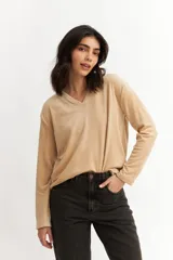 Remera color beige de plush con escote en V y mangas largas.