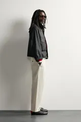 Pantalón chino regular fit de color beige, confeccionado en algodón, con bolsillos frontales y cierre de cremallera y botón, de la colección especial Aaron Levine x Zara.