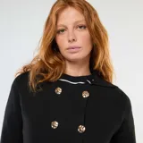 Chaleco negro de punto otomano con doble botonadura dorada y cuello solapa.