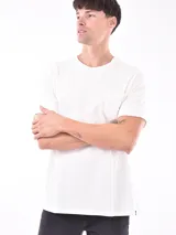 Remera negra de manga corta con cuello redondo y bolsillo en el pecho. Presenta un sutil patrón de rayas horizontales en el tejido.