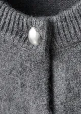Chaqueta de punto grueso color gris, con cuello redondo, diseño recto, manga larga y cierre delantero con botones.