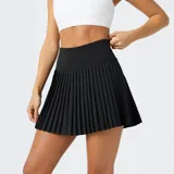 Minifalda plisada de corte deportivo, color negro, con cintura alta elástica y shorts incorporados. Confeccionada en tejido técnico transpirable con tecnología de absorción de humedad.