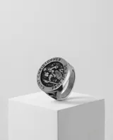 Anillo de acero con diseño circular grabado que representa a San Cristóbal, santo patrono de los viajeros, con detalles en relieve en los laterales.