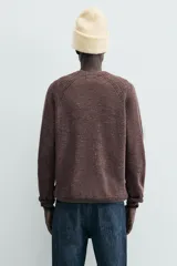 Jersey de punto con lana, de corte regular, cuello redondo y manga larga con acabados en rib.
