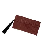 Sobre rectangular color bronce con textura croco y correa de mano negra.