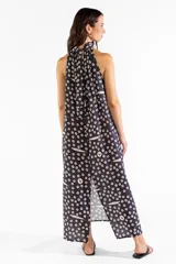 Vestido largo negro con cuello halter y estampado exclusivo de pequeños círculos y peces. Diseño sin mangas y corte fluido.