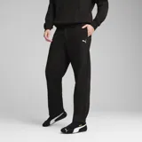 Pantalón de jogging Puma de corte relajado, color negro, con cintura elástica y logo de la marca bordado en blanco en la pierna izquierda.