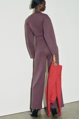 Pantalón de tiro alto con corte ancho y recto, confeccionado en tejido de punto elástico y flexible con cintura elástica.