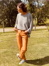 Pantalón de cuero ovino color camel, corte mom fit con tiro semi alto y tajos inferiores.