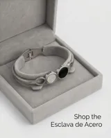 Esclava rígida de acero inoxidable con diseño de círculos entrelazados, presentando un círculo central con incrustación de nácar blanco y otro con ónix negro.