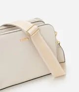 Bolso bandolera de tamaño mediano confeccionado en poliuretano color marrón, con tres compartimentos independientes con cierre de cremallera. Incluye una correa de hombro ajustable de cinta tejida bicolor y herrajes metálicos dorados.