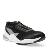 Championes deportivos Topper modelo Circus, con diseño robusto en color negro, detalles en gris y beige, y suela blanca con refuerzo en el talón. Presentan cordones jaspeados y logo de la marca en el lateral.