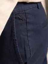 Pantalón de vestir color beige, de corte recto, con bolsillos laterales y traseros.