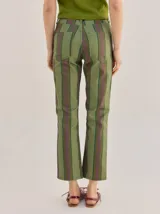 Pantalón de tiro medio con diseño de rayas verticales en tonos marrones, naranjas y amarillos, de corte recto y holgado.