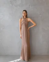 Vestido largo color mocha con escote halter cruzado y espalda descubierta. Presenta un diseño drapeado en el torso y una falda fluida con caída elegante.