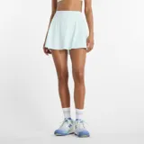 Pollera short deportiva de tiro alto, color celeste claro, con diseño de vuelo y short interior integrado con bolsillos laterales. Cuenta con tecnología de secado rápido NB DRY.
