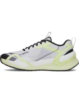 Championes de entrenamiento Under Armour Reign XT para mujer, en color blanco con detalles en amarillo fluor y negro. Cuentan con amortiguación UA HOVR de doble densidad, estructura superior de TPU y tecnología UA TriBase para mayor estabilidad y agarre.