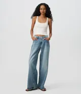 Pantalón wide leg de tiro bajo confeccionado en jean de algodón, con diseño de piernas amplias y bolsillos delanteros y traseros.