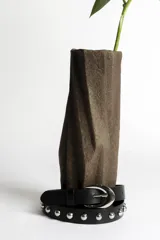 Cinturón negro de cuero sintético con tachas plateadas y hebilla metálica plateada.