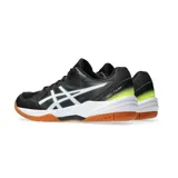 Championes Asics Gel-Task 3, diseñados para deportes de interior. Presentan un diseño en color negro con detalles en blanco y toques de amarillo neón en el talón. Cuentan con una suela de goma color caramelo, ideal para superficies de cancha, y el logo de la marca en los laterales.