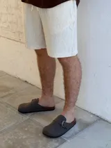 Zuecos grises con hebilla metálica ajustable y plantilla anatómica de corcho.