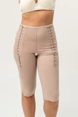 Calza capri color piel, de tela de faja de alta contención, con broches laterales reforzados con dos medidas y orificio sanitario en la entrepierna.