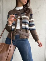 Saco tejido de punto con diseño a rayas horizontales en tonos marrón, blanco y gris. Presenta cuello redondo, cierre frontal con botones y mangas largas.