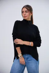 Sweater negro de cuello alto, manga larga y corte holgado con aberturas laterales.