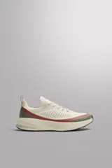 Zapatilla de correr Zara Athleticz, color beige con detalles en verde militar y rojo. Presenta una parte superior de tejido de punto transpirable, puntera y talón recubiertos con material Shield Protect Max, ajuste con cordones, tirador trasero, plantilla OrthoLite® extraíble, entresuela Spume Foam V3 y suela de goma.