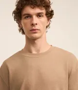 Remera color arena de corte relaxed, confeccionada en algodón texturizado.