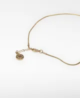 Collar largo con cadena metálica dorada y un dije geométrico asimétrico compuesto por piezas metálicas combinadas en tonos plateado y dorado con efecto de pliegues.