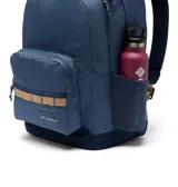 Mochila urbana de 30 litros con dos compartimentos principales, funda acolchada con forro polar para laptop de hasta 15 pulgadas, bolsillos laterales para botellas y base acolchada. Presenta un diseño en azul con detalles en beige y logo de la marca en el frente.