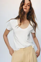 Camiseta de algodón con corte regular, escote redondo amplio y manga corta. Presenta un diseño básico con bajo recto.