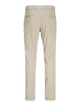Pantalón chino slim de tiro medio color beige, con cierre de cremallera y bolsillos laterales.