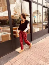 Pantalón slouchy de cuero ovino italiano color burdeos, corte mom fit con tiro semi alto, tajos inferiores y bolsillos laterales.