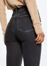 Jeans de corte skinny y tiro alto, confeccionados en tejido denim elástico de algodón. Presentan diseño clásico de cinco bolsillos, trabillas para cinturón y cierre frontal con cremallera y botón.