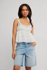 Musculosa de algodón blanca con detalles de puntilla festoneada, escote cuadrado, tiras regulables y diseño en capas con volados.