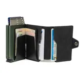 Billetera compacta de cuero negro con costuras verdes y mecanismo de eyección de tarjetas. Presenta el nombre "Baleine" grabado en la parte inferior frontal.