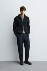 Pantalón regular fit color azul marino, confeccionado en tejido elástico. Cuenta con bolsillos frontales, bolsillos traseros de vivo con botón y cierre frontal con cremallera y botón.